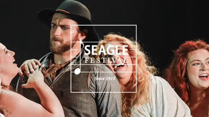 seagle festival logo over image of two people singing